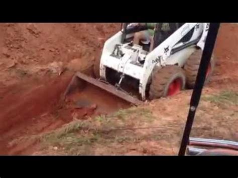 digging tunnel with skid steer|digging holes with skid steer.